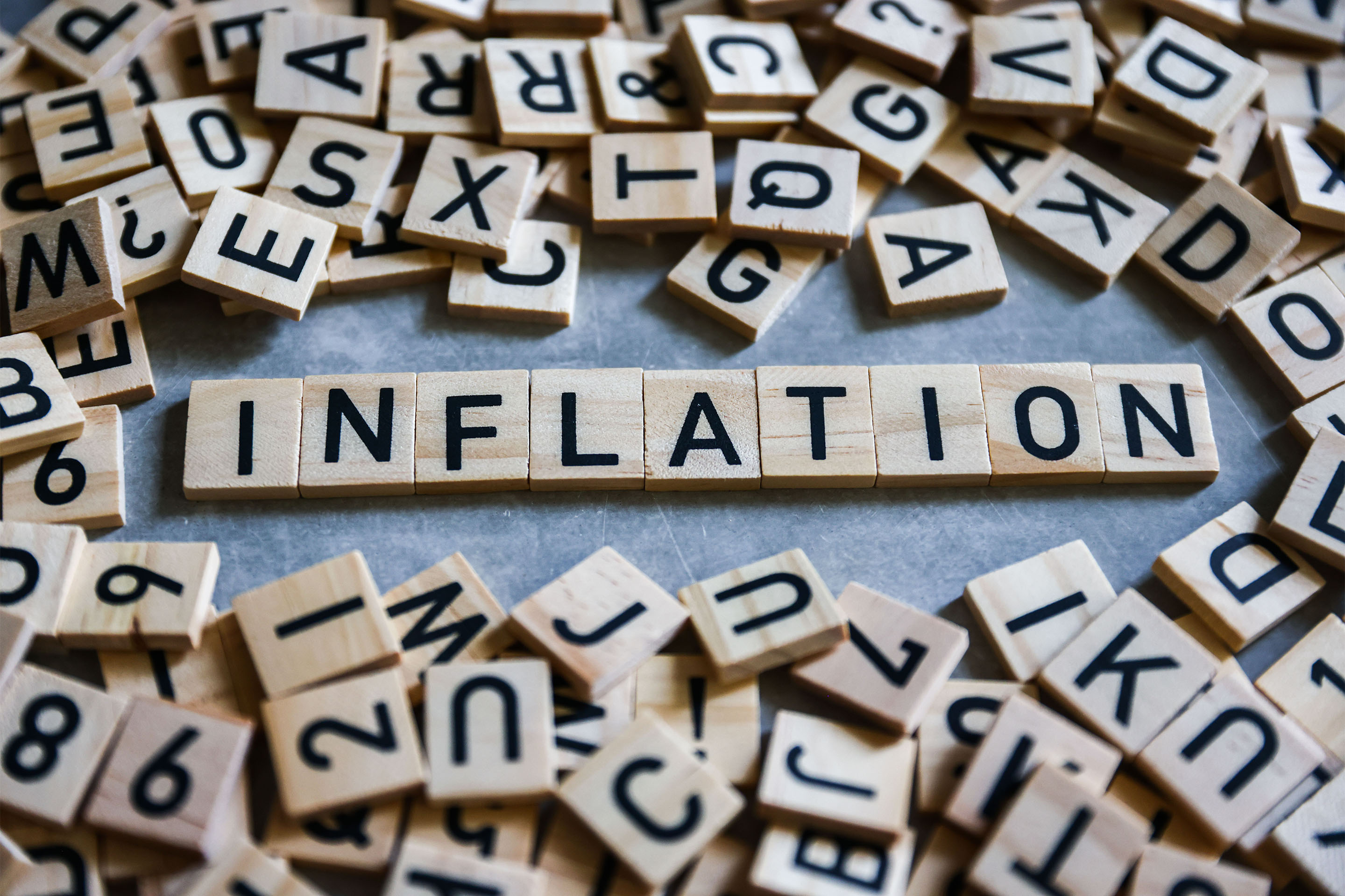 Word 'Inflation' is written with wood tile letters arranged for illustration - Inflationsmonitor