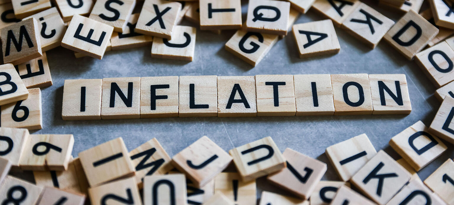 Word 'Inflation' is written with wood tile letters arranged for illustration - Inflationsmonitor